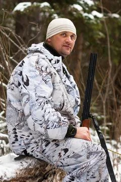 Hunter resting in winter forest Stock Photos