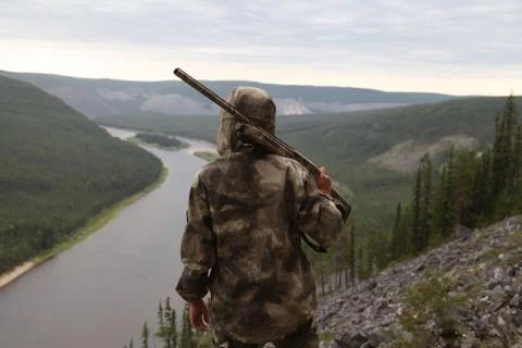 Hunter with a rifle on the mountain Stock Photos