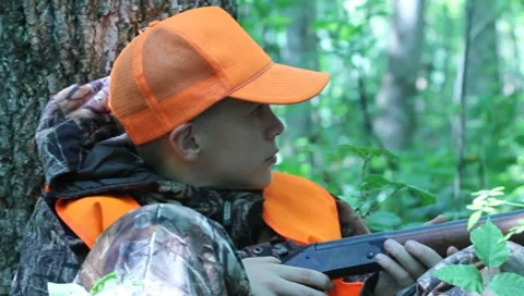Hunter with rifle ready from sitting position(HD) c Stock Footage 8655648