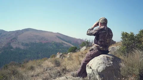 Hunter on rock with binoculars Stock Footage 151808179