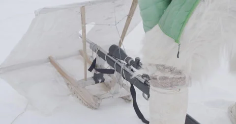 Hunter sets up his snow shield for his rifle. Hunting seal in Qaanaq, Greenland Stock Footage 138210668