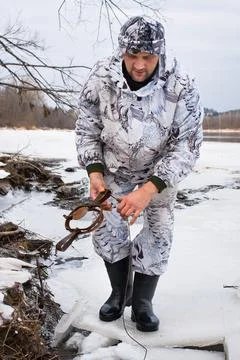 Hunter setting a leghold trap Stock Photos