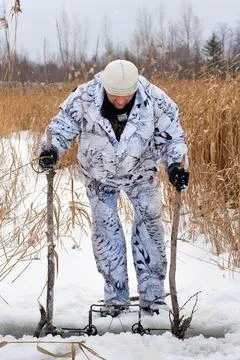 Hunter setting a trap for beaver Stock Photos