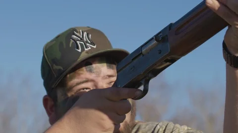 Hunter shooting semi-automatic shotgun multiple times with ejecting shells. 库存影片 112980302
