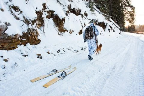 Hunter with skis on the road Stock Photos