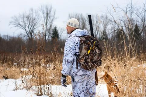 Hunter on snowy field Stock Photos