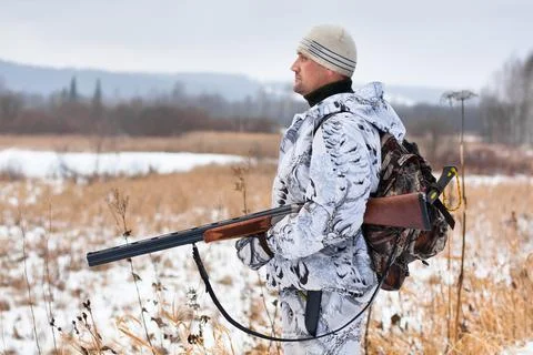 Hunter on the snowy field Stock Photos