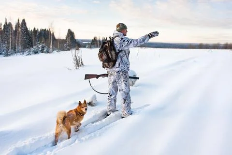 Hunter on the snowy road Stock Photos