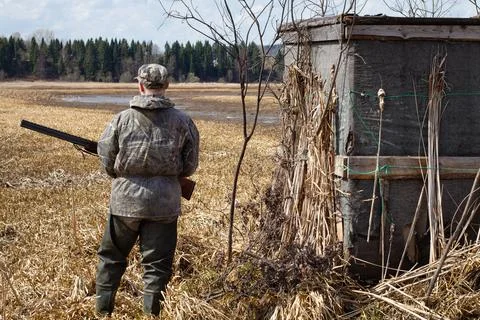 The hunter stands next to the duck blind Stock Photos