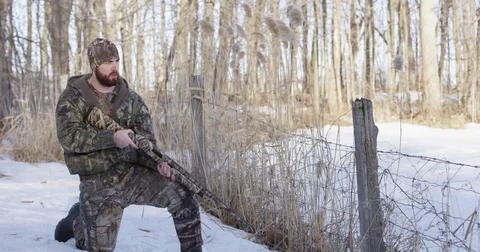 Hunter takes aim and fires ejecting shell slow motion winter 4k Stock Footage 73784773