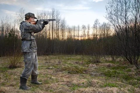 The hunter takes aim at the target in the evening Stock Photos