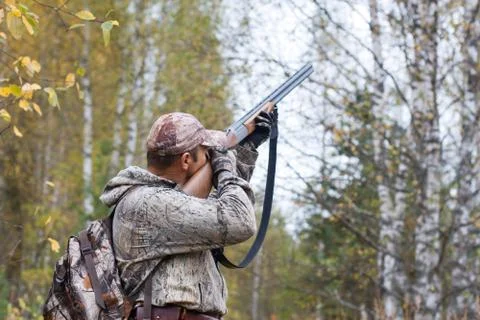 Hunter taking aim in the wildfowl Stock Photos