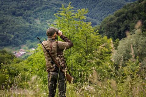 Hunter using binoculars to search for prey Stock Photos