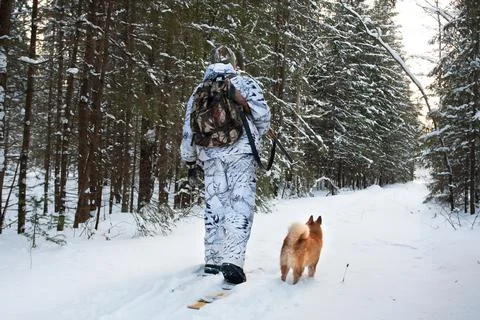 Hunter walking on the skis Stock Photos