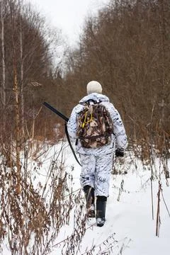 Hunter walking on the snowy glade Stock Photos