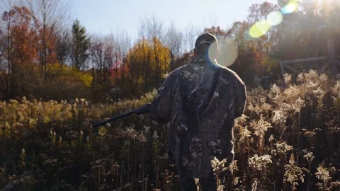 Hunter Walking through Field with Rifle - 1080p 60fps Rec709 Stock-Footage 104425993