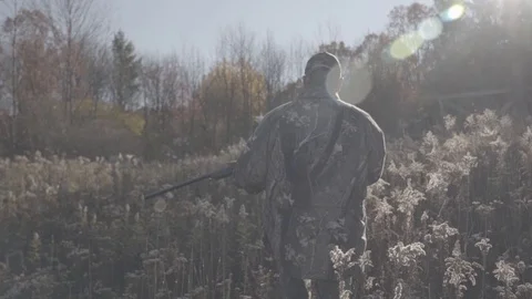 Hunter Walking through Field with Rifle - 1080p 60fps Slog3 Stock-Footage 104426031