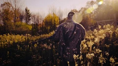 Hunter Walking through Field with Rifle - 1080p 60fps Stylish Grade Stock-Footage 104426033