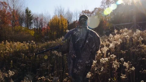 Hunter Walking through Field with Rifle in Slow Motion - 1080p 60fps Rec709 Stock Footage