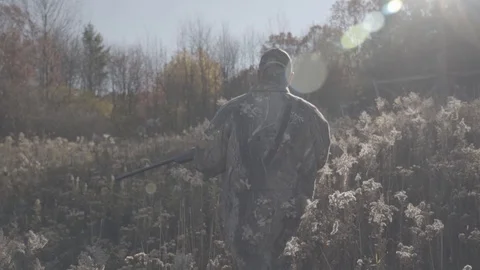Hunter Walking through Field with Rifle in Slow Motion - 1080p 60fps Slog3 Stock-Footage 104426203