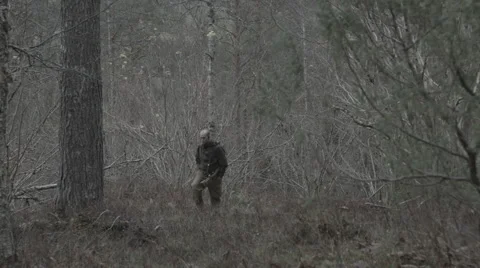 Hunter walking through forrest - Panning shot Stock Footage 43716108