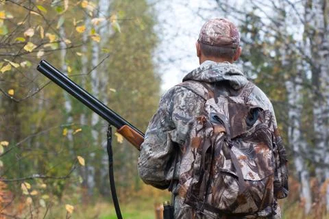 Hunter walking through the woods Stock Photos