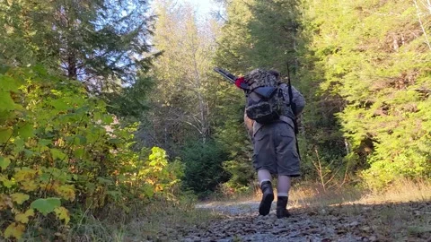 Hunter walking up trail Stock Footage 172564403