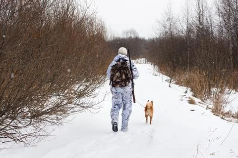 Hunter walking on the winter road Stock Photos