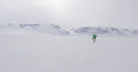 Hunter walks toward camera with snow shield and rifle Stock Footage 138218580