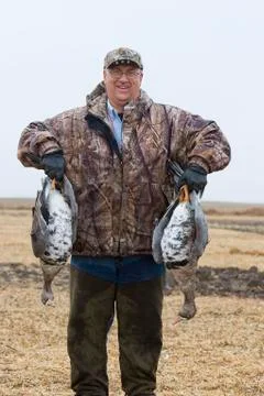 Hunter with Whitefronted Geese Stock Photos