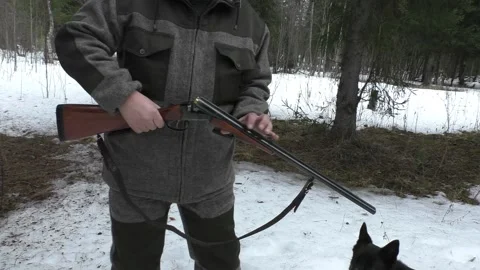 Hunter in the winter forest charge a gun. Stock Footage 151670762