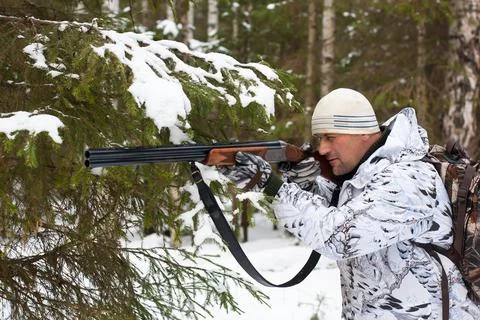 Hunter in winter forest Stock Photos