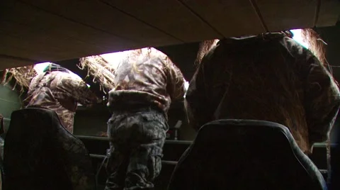 Hunters observing from hunting blind while duck hunting Stock Footage 54591951
