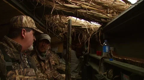 Hunters observing from hunting blind while duck hunting Stock Footage 54592047