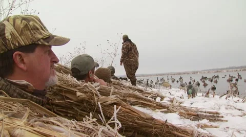 Hunters observing from hunting blind while duck hunting Stock Footage 54592058