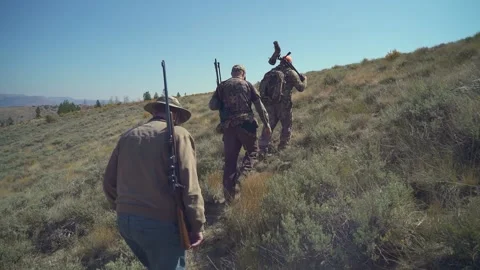 Hunters tracking through brush Stock Footage 151808226