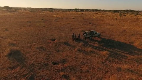 Hunters unload the car in the savannah of Namibia. Stock Footage