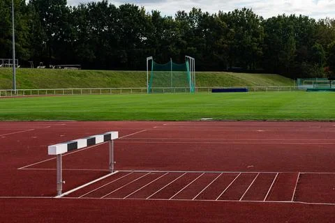 Hurdles setup ready for training on a quiet athletic field Stock Photos