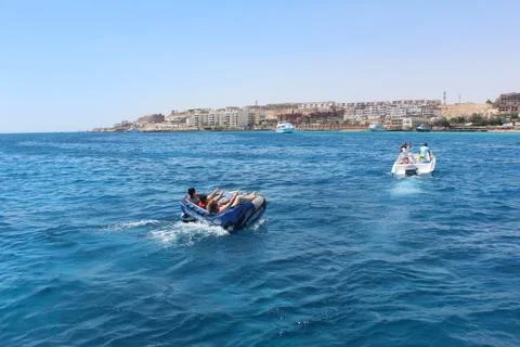Hurghada, Egypt - 05/14/2018: Racing on a pillow in the Red Sea behind a boat Stock Photos