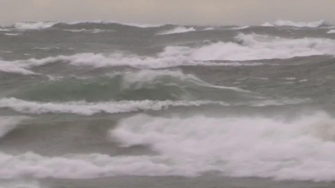Hurricane force storm winds with waves crashing ashore and flooding beach Stock Footage 69878659