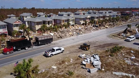 Hurricane Michael Damage Debris Clearing Backhoe Mexico Beach Florida wide shot Stock Footage 97402492