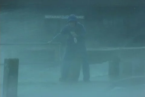 Hurricane reporter in wind rain Stock Footage 15436192