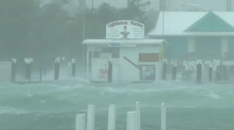 Hurricane whipped wind and waves batter a dock and marina Stock Footage 12570135
