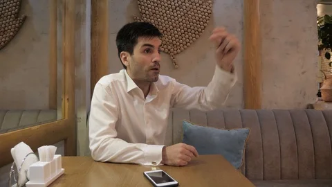 Hurrying man snaps fingers to call waiter in pizzeria Stock Footage 106328113