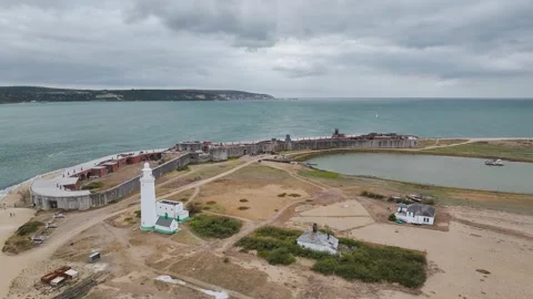 Hurst Point Lighthouse and Hurst Castle from drone over Hurst Spit, Milford on Stock Footage 330617730