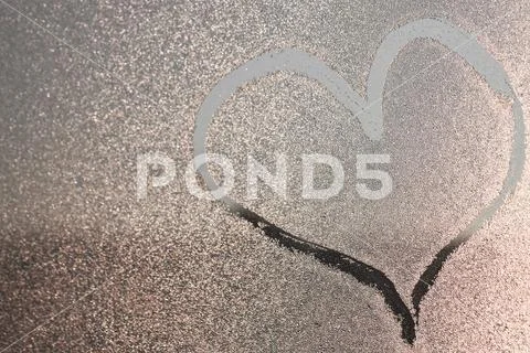 Hurt image on the freezen window. Picture on the Iced water drops. Winter pai Stock Photos
