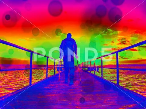 Hurt man on pier in the sunrise. The wharf construction above sea follow Sun Stock Photos