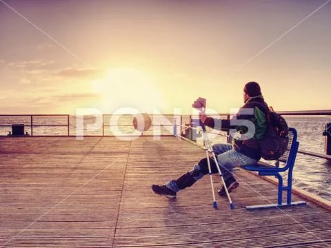 Hurt passenger is waiting for ferry. Empty moring harbor pier, Stock Photos