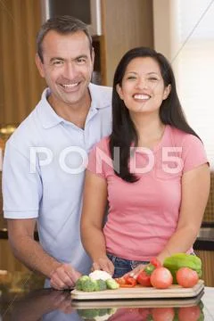 Husband and wife preparing meal,mealtime together Stock Photos