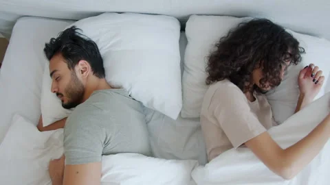 Husband and wife sleeping in comfortable... | Stock Video | Pond5